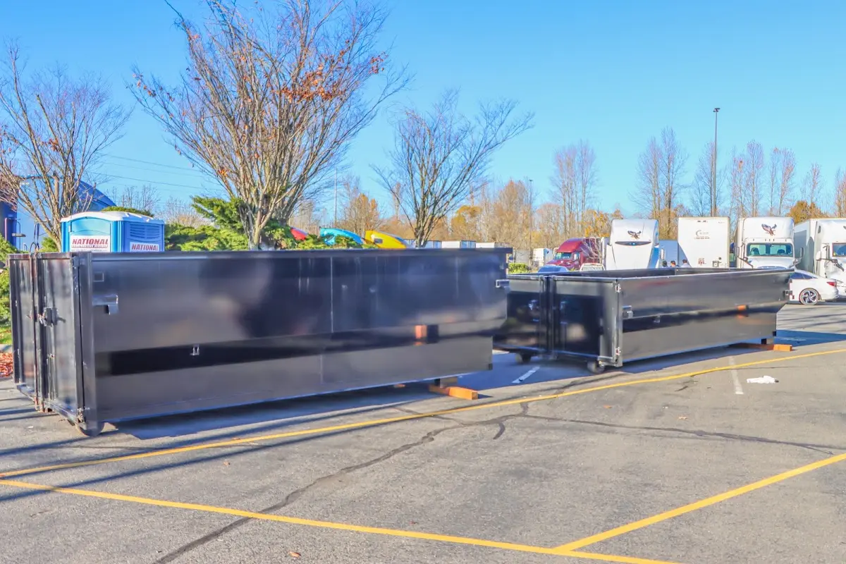 Professional dumpster rental service with roll-off container on residential driveway in Rockcreek